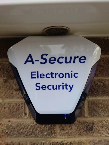 A clean white A-Secure Electronic Security bell box fitted to a building